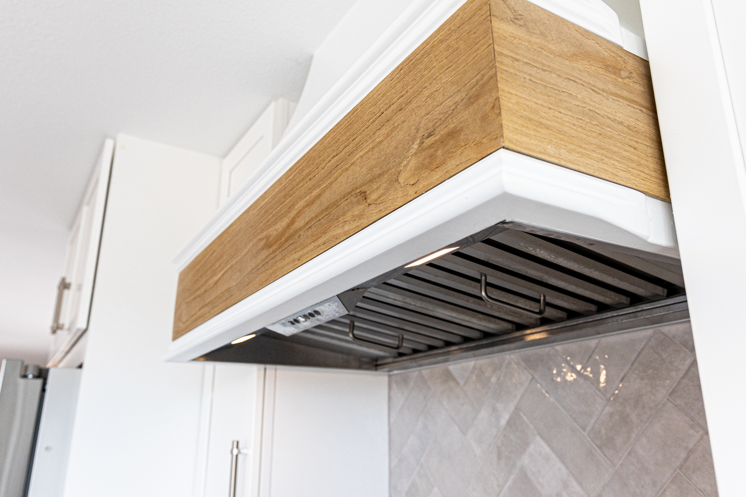  Close-up of kitchen range hood with wooden accent